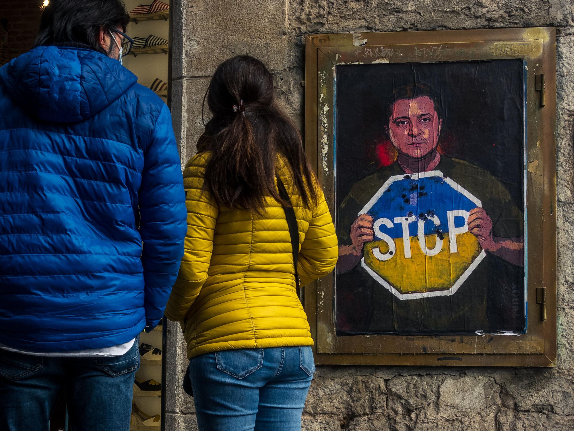photo of people passing by a Zelensky graffiti in Barcelona, Spain