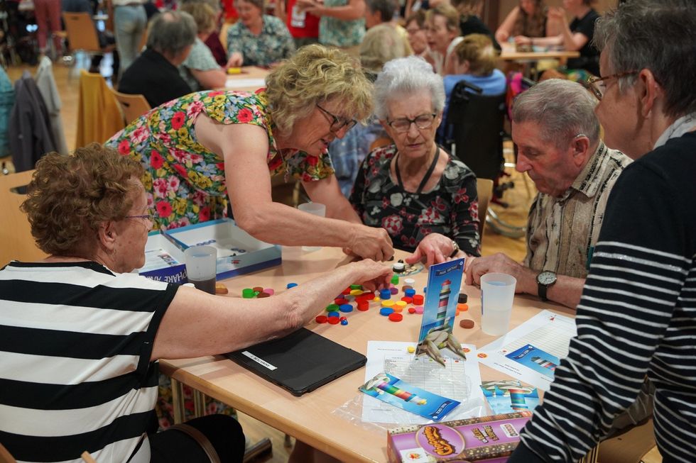 Photo of people playing board games at a festival in France.