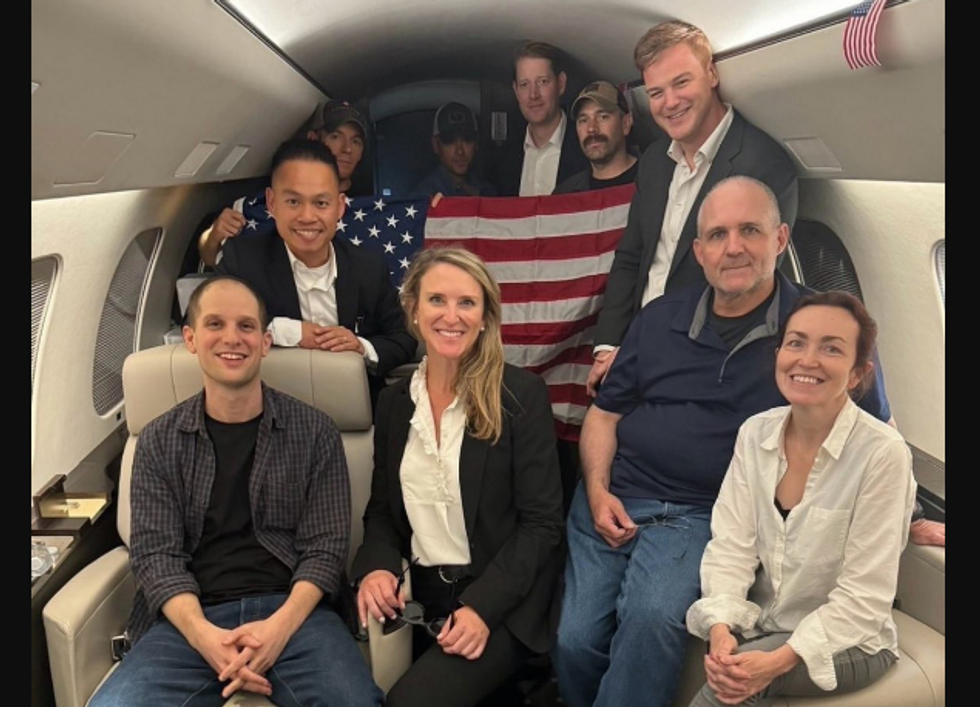 photo of people posing with an American flag