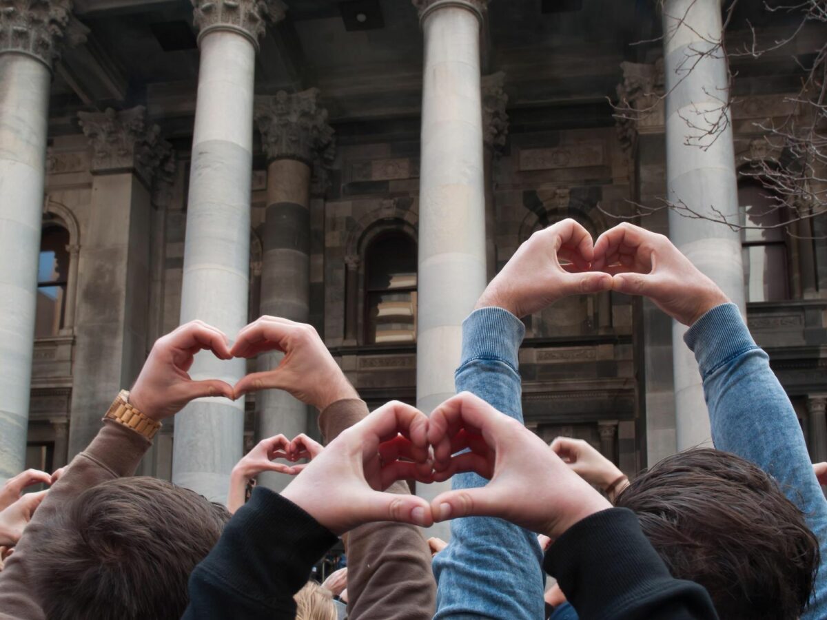 Photo of people putting their hands up in heart shapes following ​Slovenia's decision to legalize same-sex marriage and adoption