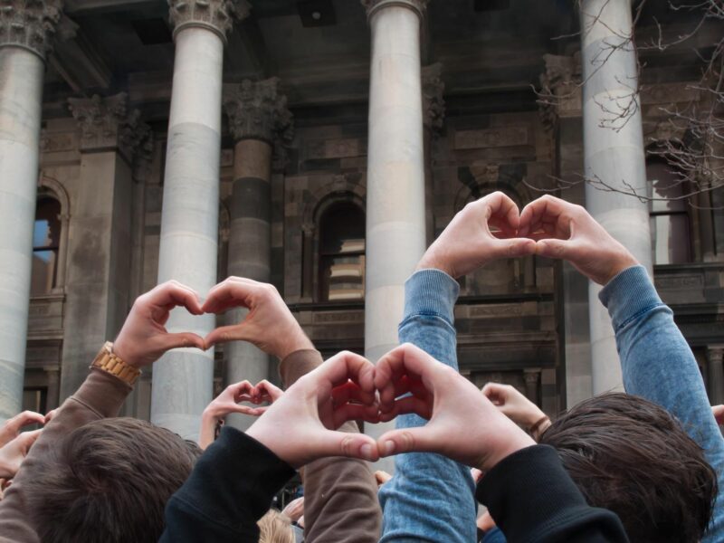 Photo of people putting their hands up in heart shapes following ​Slovenia's decision to legalize same-sex marriage and adoption