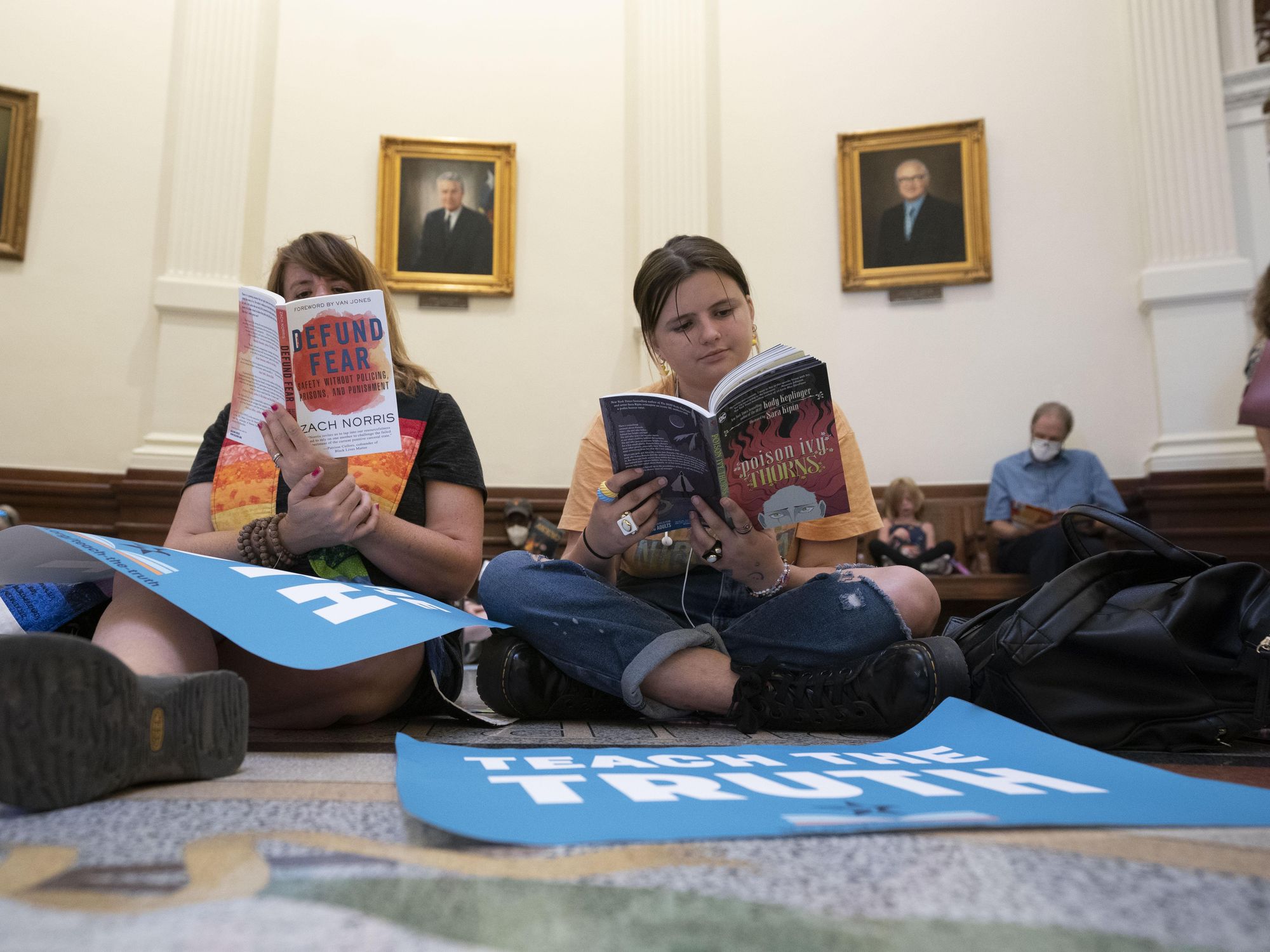 photo of people reading books on the floor of texas legislature