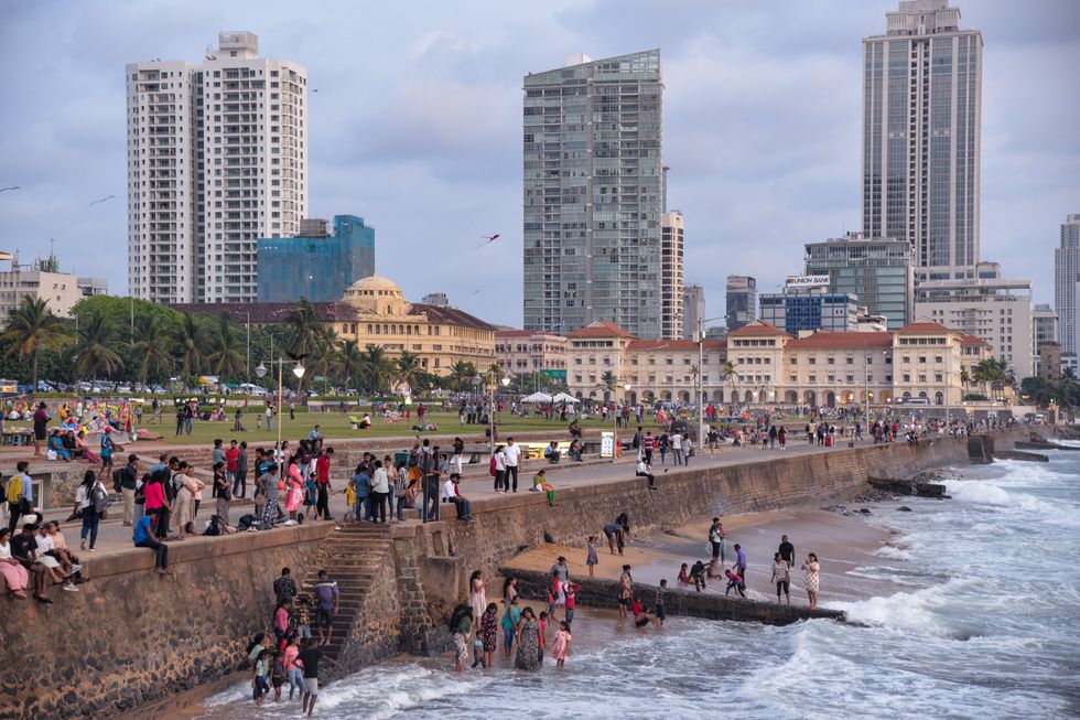 Photo of people sitting by the sea in Colombo, Sri Lanka
