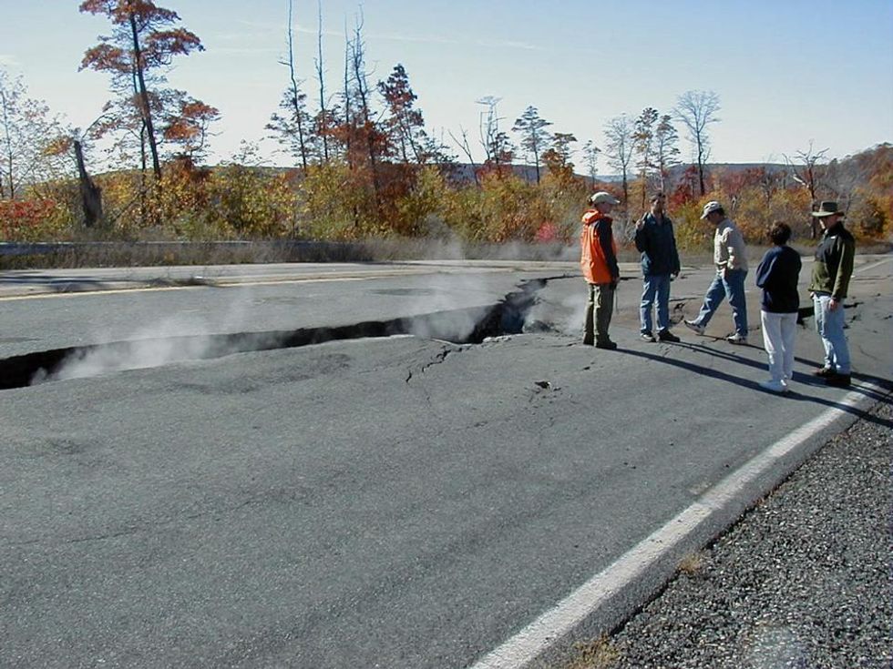 Photo of people standing next to a cracked highway from subsurface coal fire near Centralia, Pennsylvania