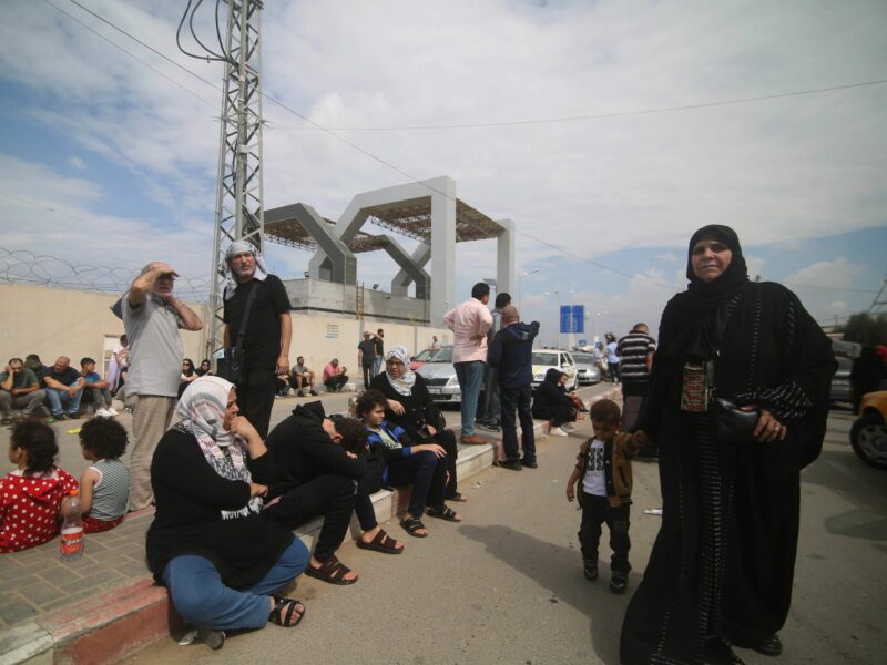 Photo of people waiting at the Rafah border crossing between Gaza and Egypt