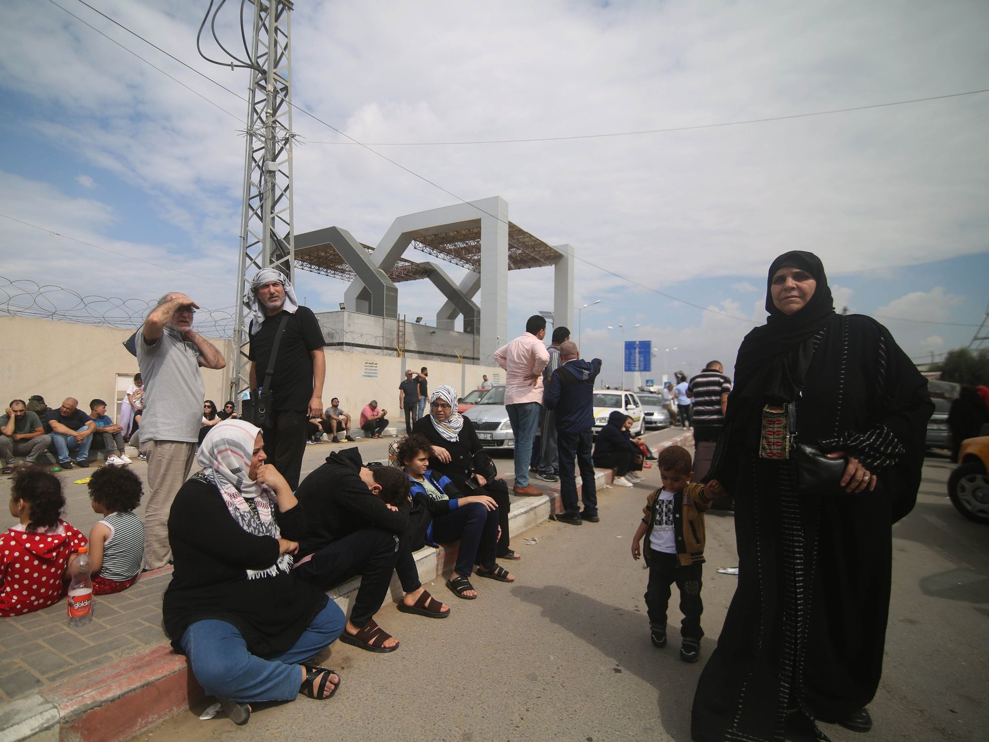 Photo of people waiting at the Rafah border crossing between Gaza and Egypt