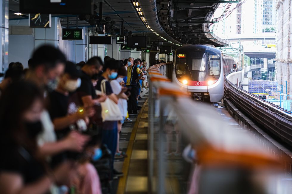 Photo of people waiting for the train in Hong Kong wearing face masks