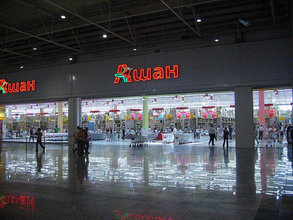 Photo of people walking by an Auchan supermarket in Moscow​