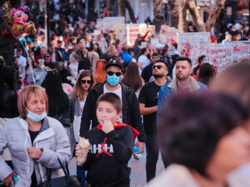 Photo of people walking in the streets of Plovdiv, Bulgaria, some wearing a facemask