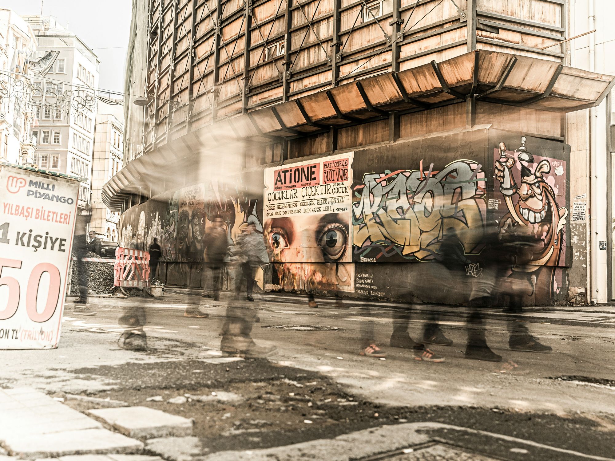Photo of people walking past graffitied walls in Istanbul, Turkey