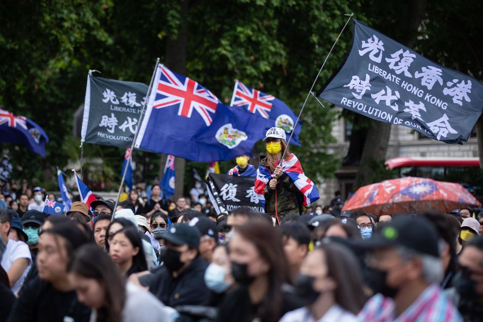Photo of people waving flags during the anniversary of Hong Kong Protest in London