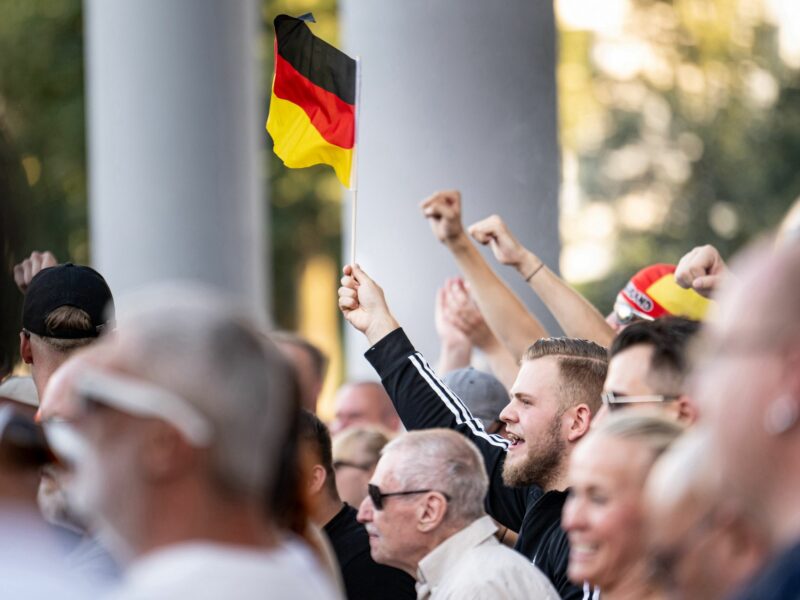 photo of people waving german flag