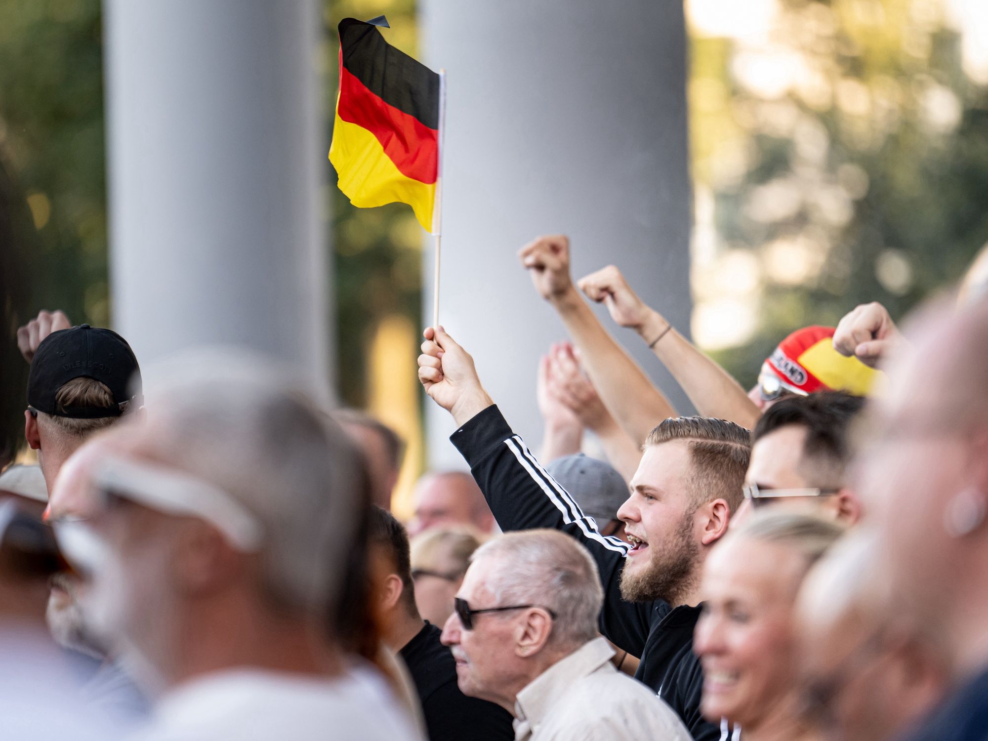 photo of people waving german flag