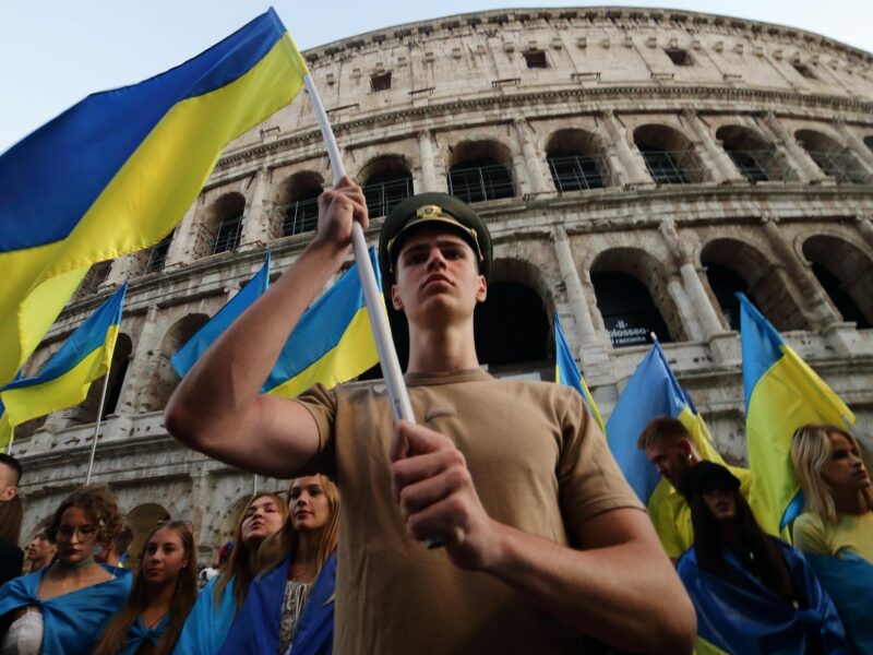 Photo of people waving Ukrainian in front of Rome's Colosseum.
