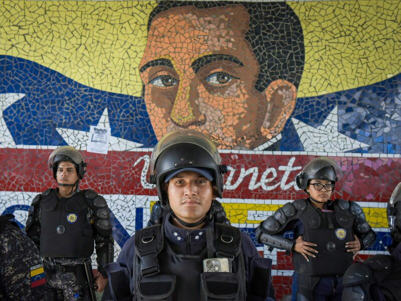 photo of police in front of mural
