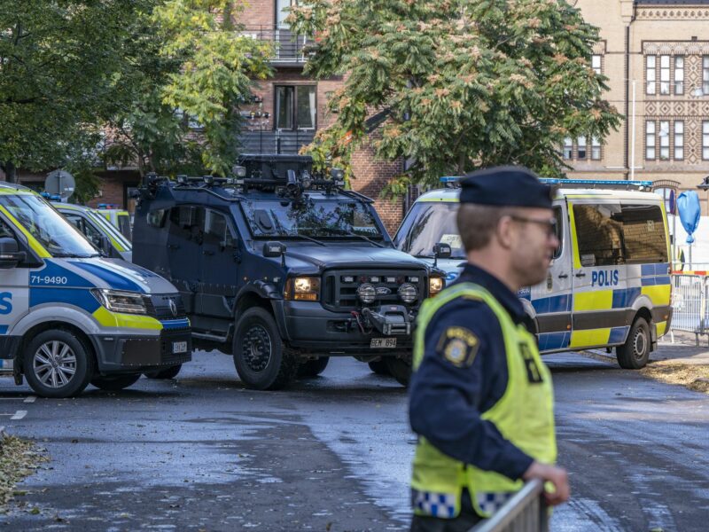 Photo of policy cars and security personnel outside Malmö's synagogue before a visit by Swedish Prime Minister Stefan Lofven for the Malmö International Forum on Holocaust Remembrance and Combating Antisemitism, on Oct. 12, 2021