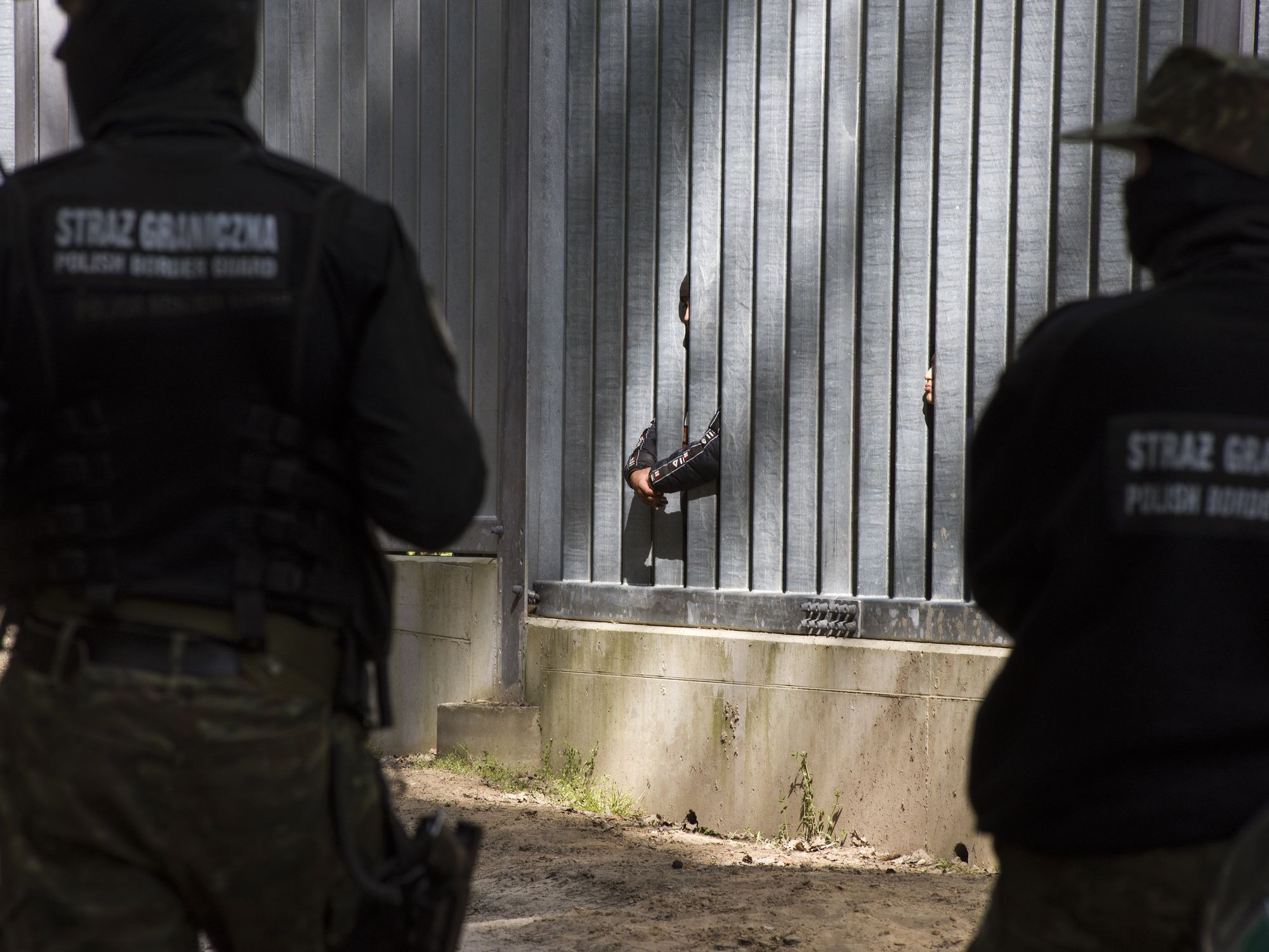 Photo of Polish border guards watching migrants at the country's border with Belarus