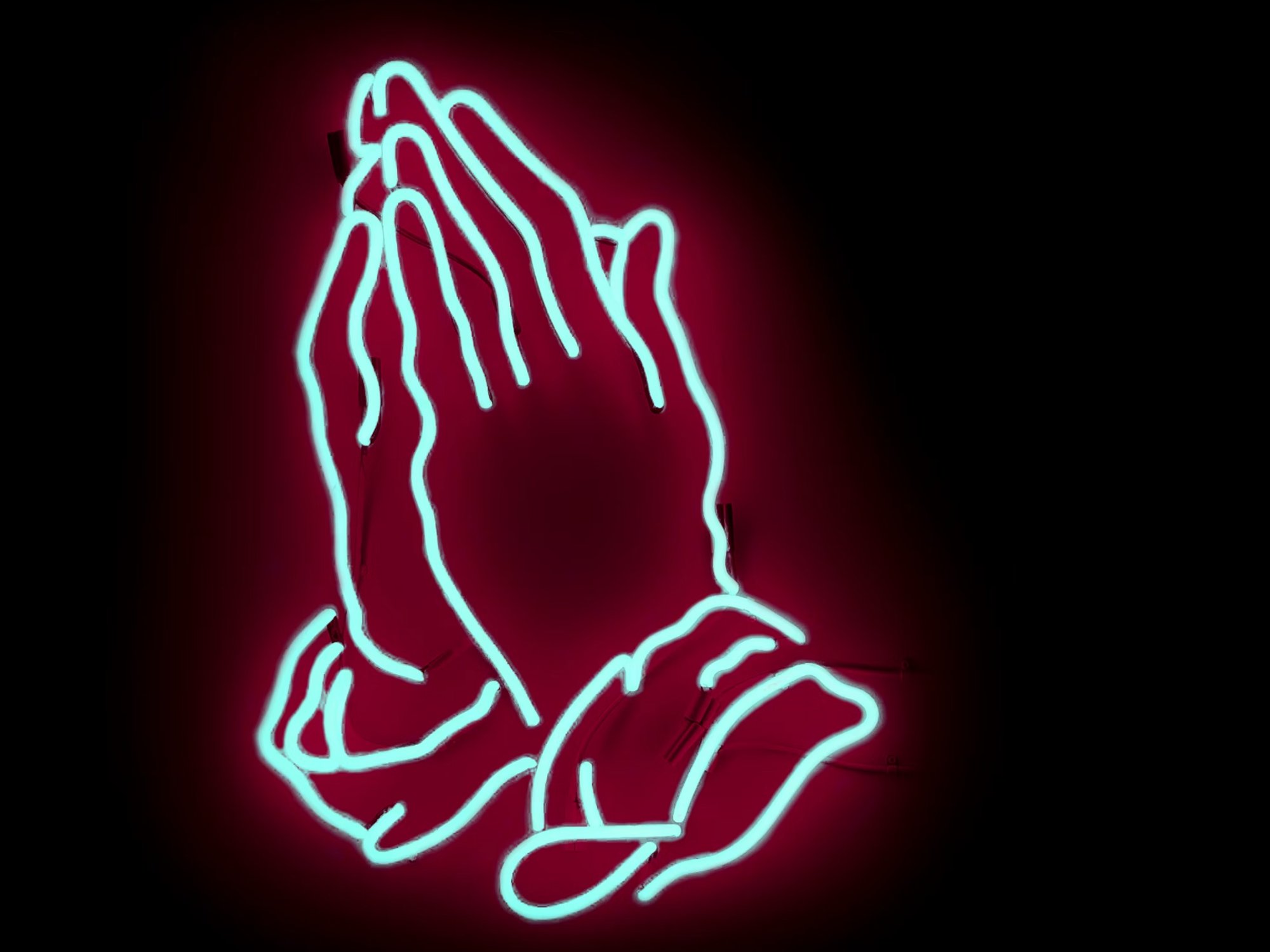 Photo of praying hands in neon sign