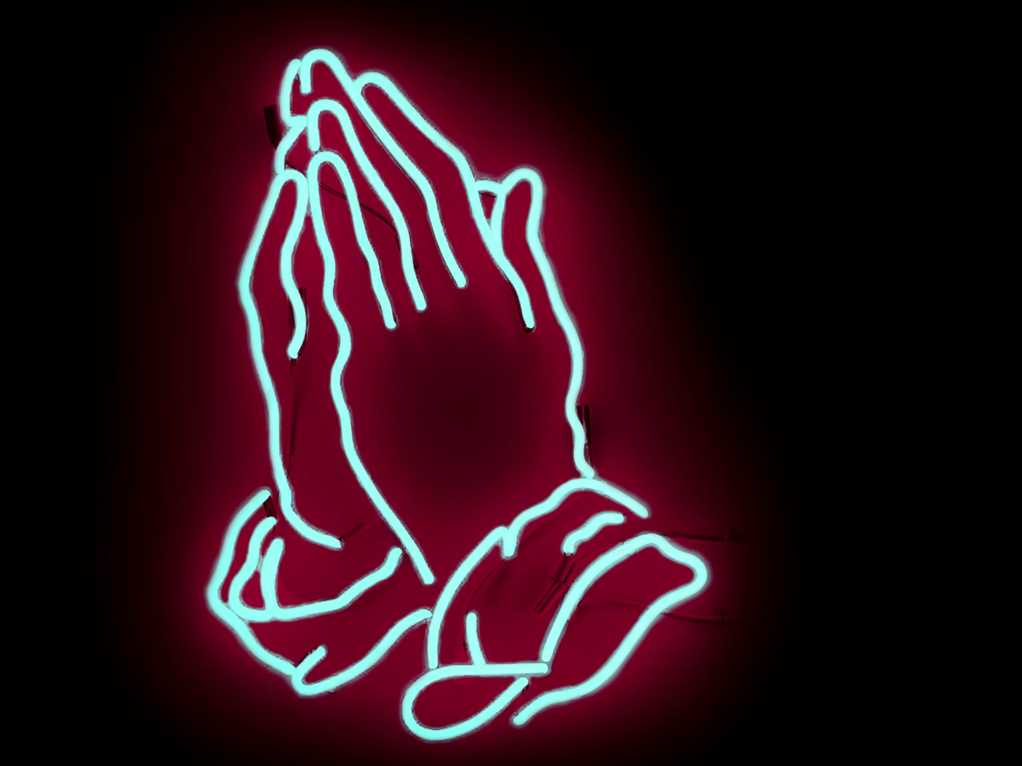Photo of praying hands in neon sign