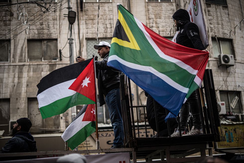Photo of pro-Palestine protesters waving flags in downtown Amman, Jordan