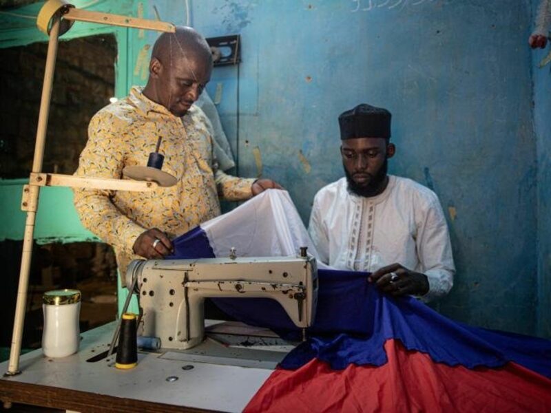 Photo of Pro-Russia activist Ahmed Issoufou Bello sewing a Russian flag