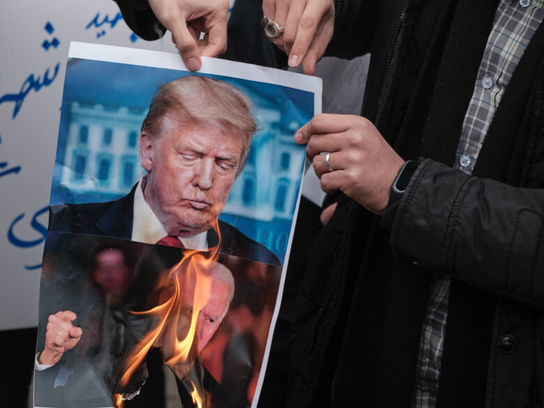Photo of protesters burning a photo of then U.S. presidential candidates Joe Biden and Donald Trump back in 2020