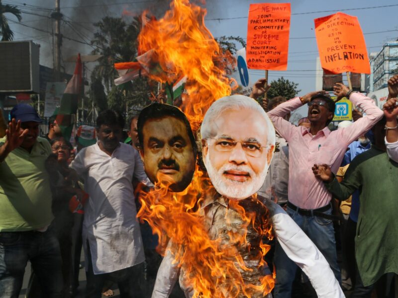 Photo of protesters burning effigies of Narendra Modi and Gautam Adani in Kolkata as part of a protest earlier this year