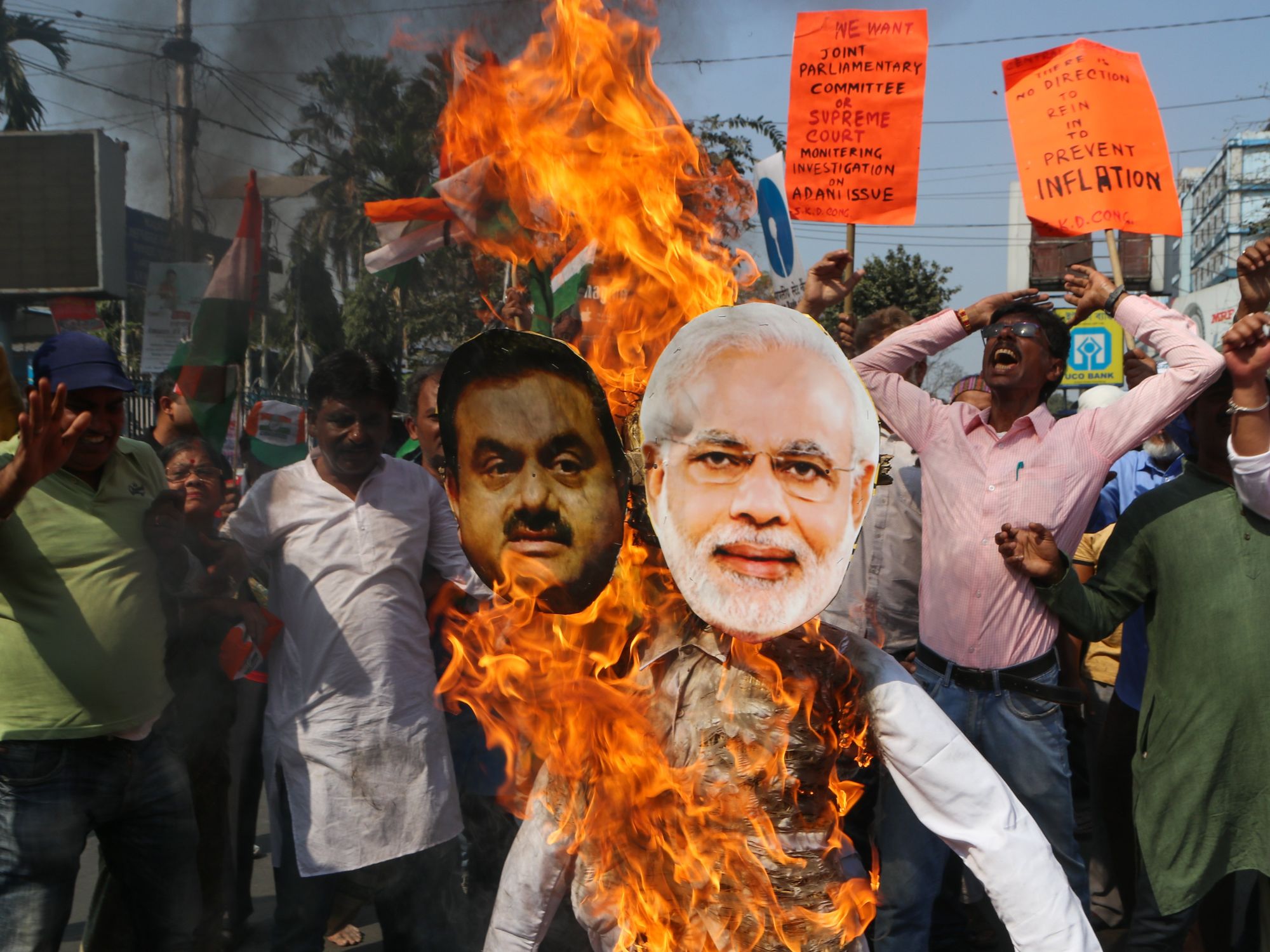 Photo of protesters burning effigies of Narendra Modi and Gautam Adani in Kolkata as part of a protest earlier this year
