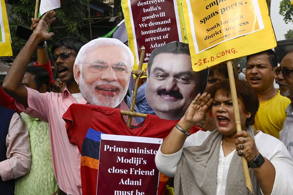 Photo of protesters carrying cardboard cutouts of Adani and Modi, as they demand the arrest of Gautam Adani over alleged corruption charges, during a protest on November 22, 2024 in Kolkata, India.