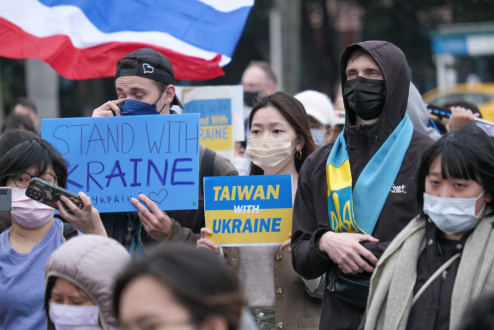 Photo of protesters carrying signs showing Taiwan's support of Ukraine, during a march in Taipei on March 6