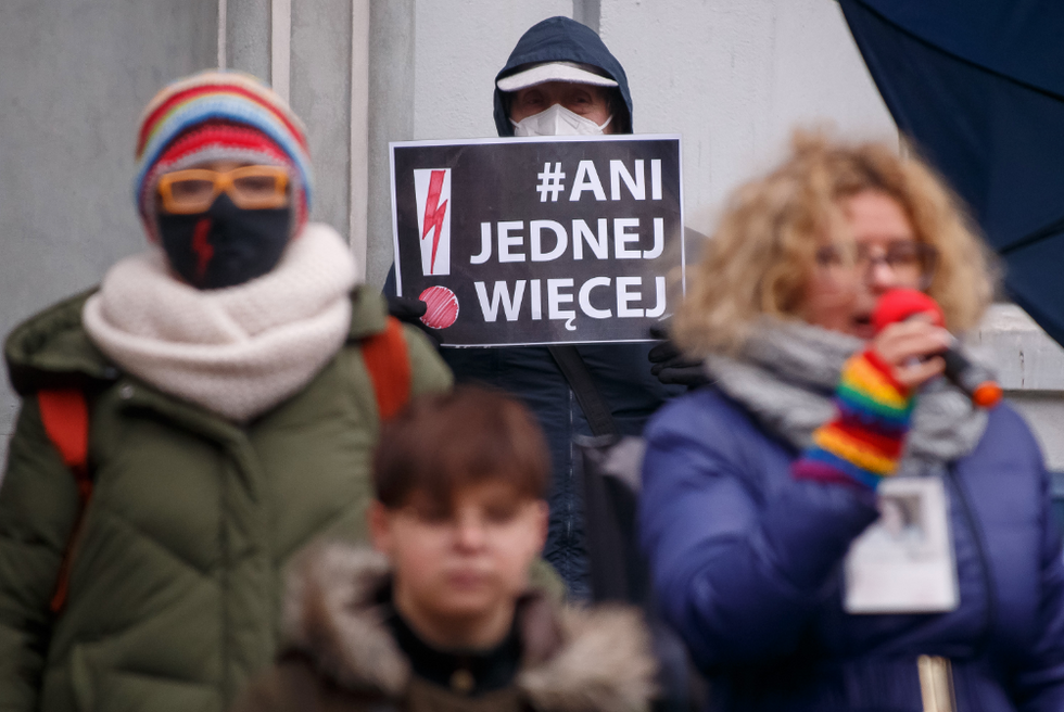 Photo of protesters during a pro-choice rally in Gdansk in 2021, with one protester holding a sign that reads ''Not one more''.