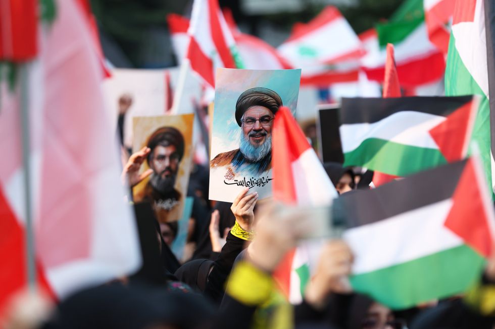 Photo of protesters holding a photo of slain Hezbollah leader Hassan Nasrallah among Palestinian flags, as part of a demonstration in Tehran, Iran, on Sept. 30.