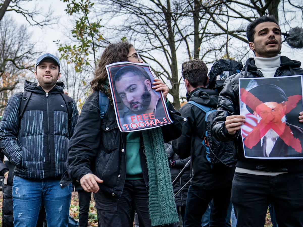 Photo of protesters holding photographs