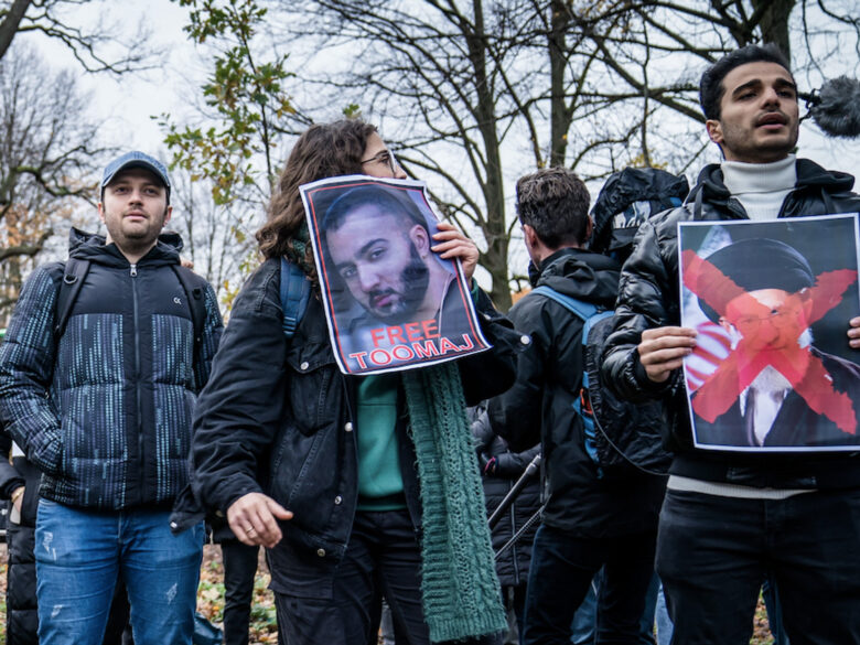 Photo of protesters holding photographs