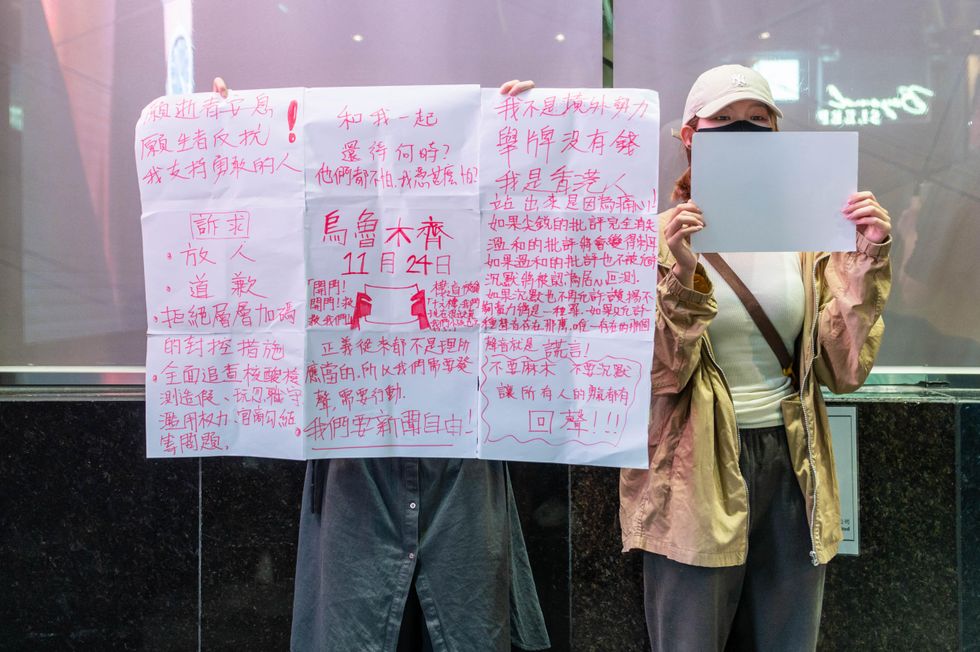 Photo of protesters in China holding up signs