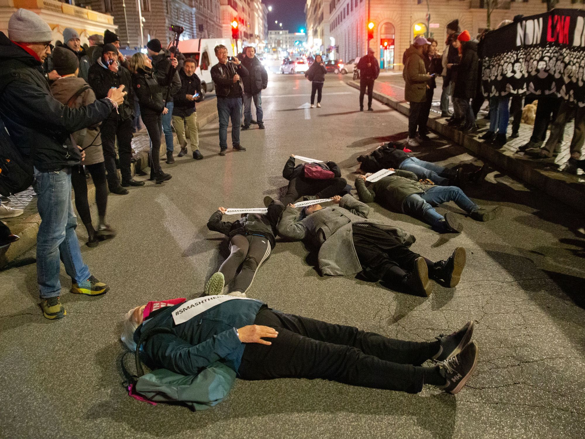 photo of protesters lying down on the street in Rome