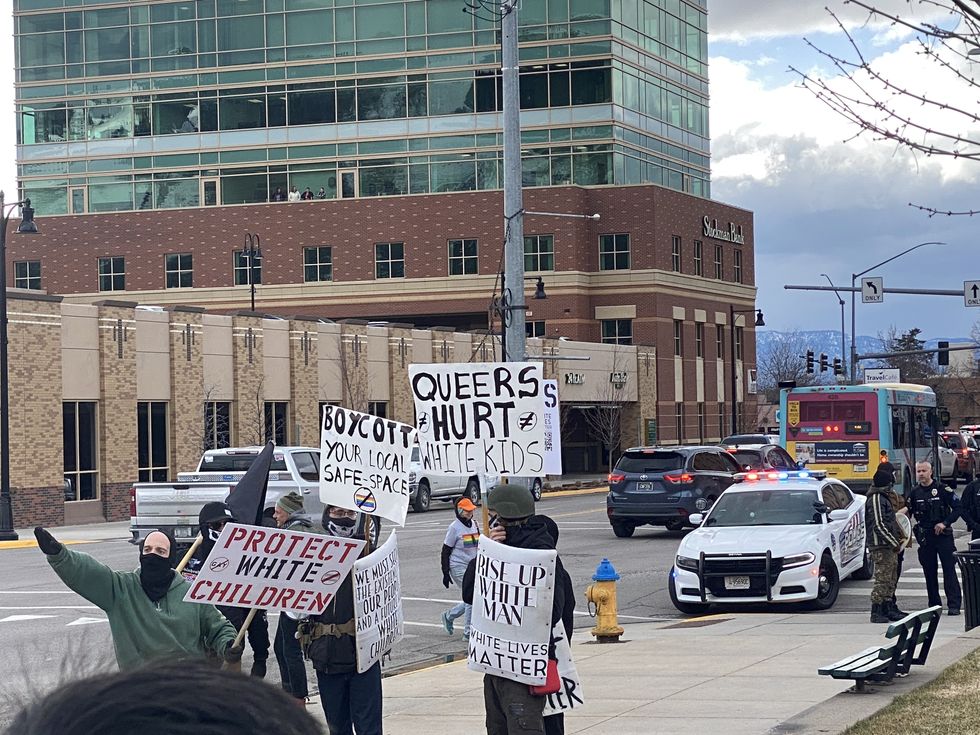 Photo of protestors with slogans against Missoula's trans day of visibility rally.