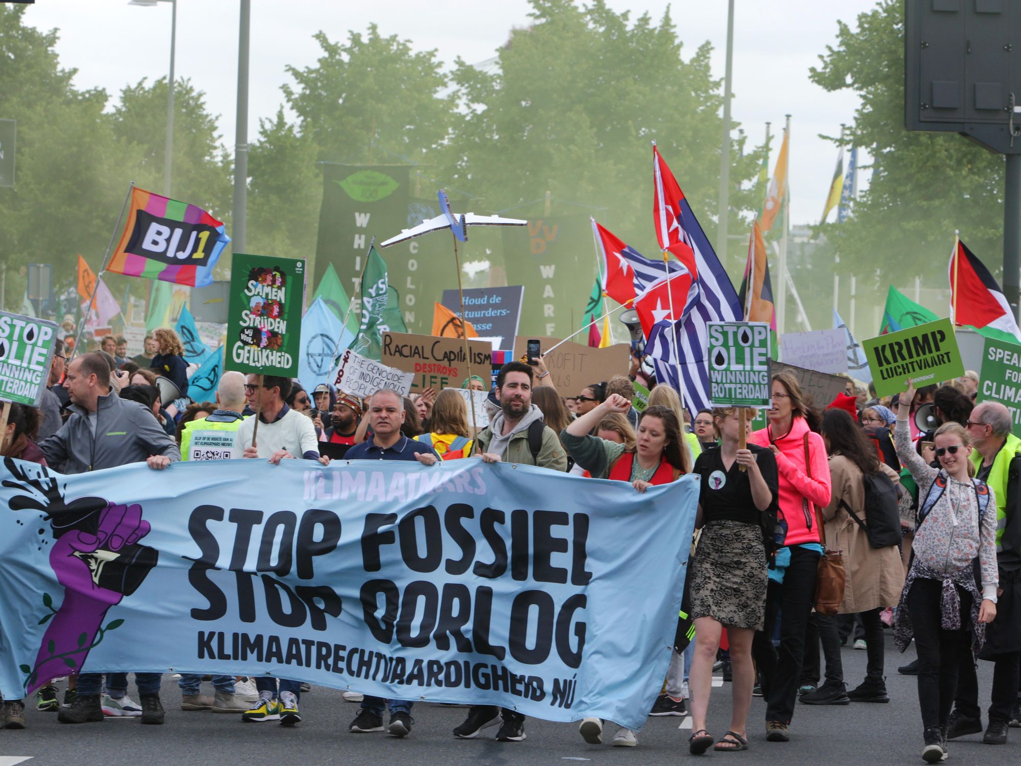 photo of protests holding a banner to stop fossil fuel
