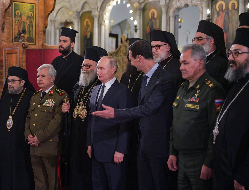 photo of putin and assad in a church