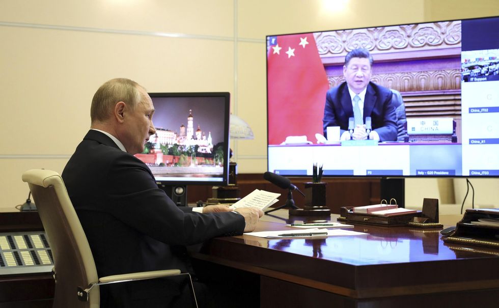 photo of putin connecting on video conference with xi