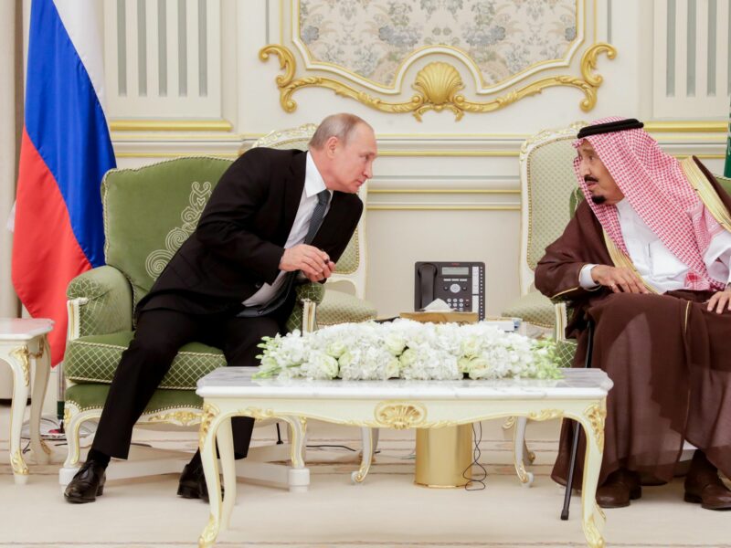 photo of putin leaning over to talk to saudi king salman
