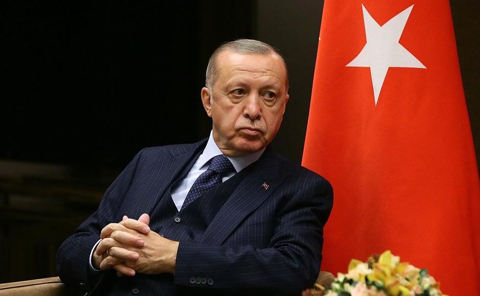 Photo of Recep Tayyip Erdogan with his hands crossed