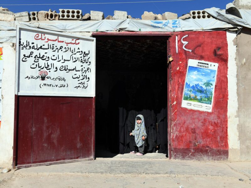 photo of red doors and a small child