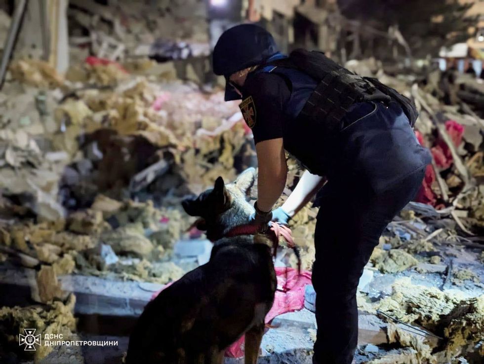 Photo of rescuers after a Russian missile targeted buildings in Ukraine