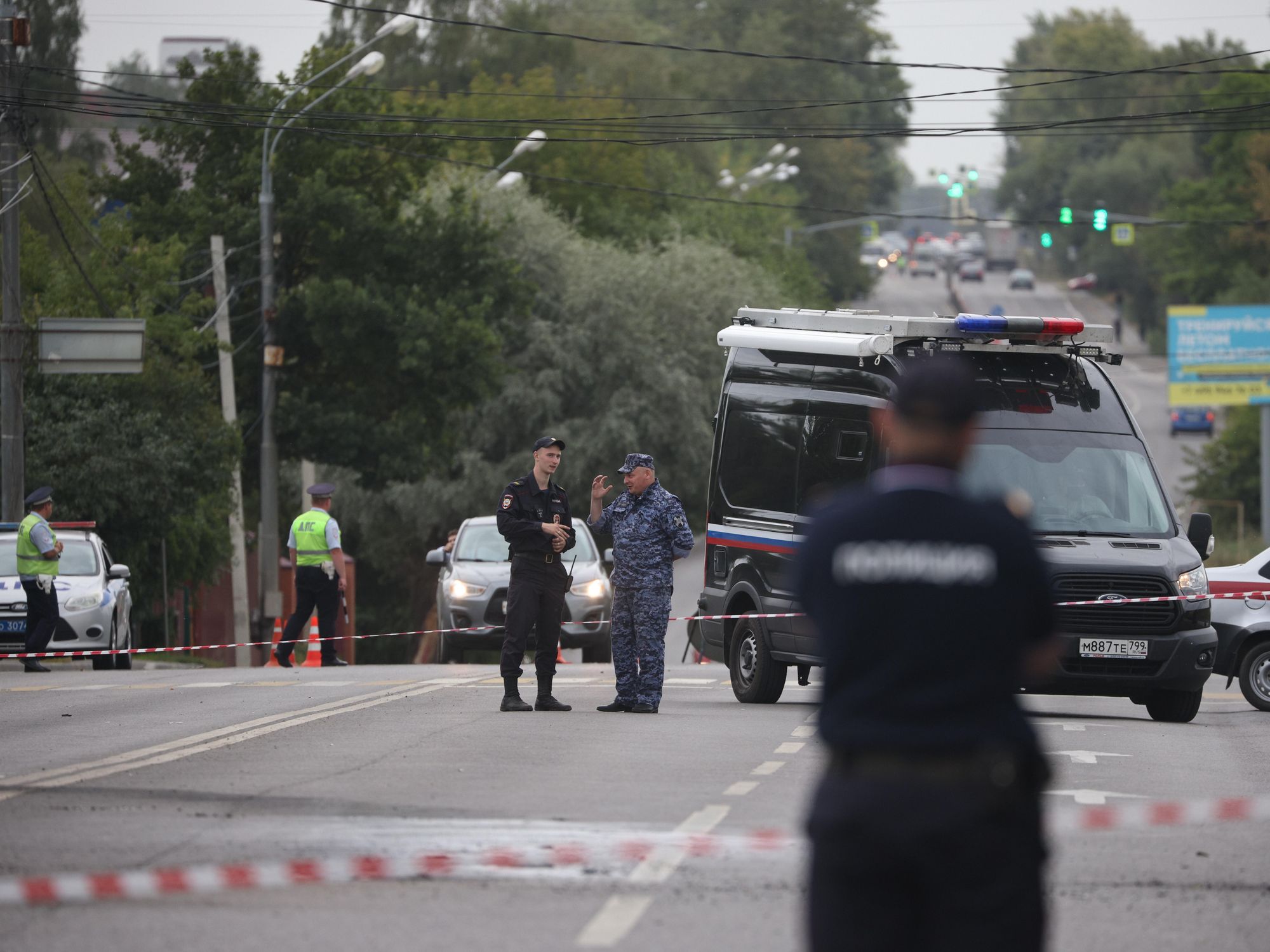 Photo of Russian National officers guarding the scene of a car bombing of journalist Darya Dugina