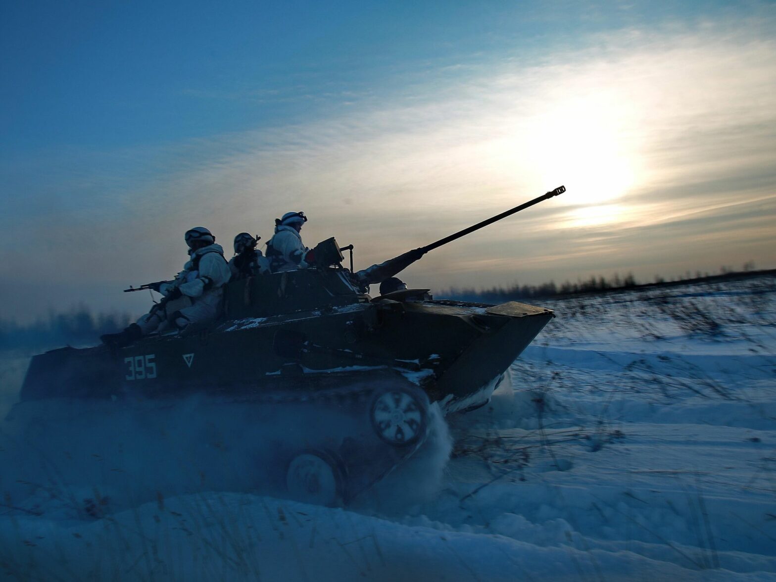Photo of Russian on a tank ploughing through the snow in the Kostroma region of Russia