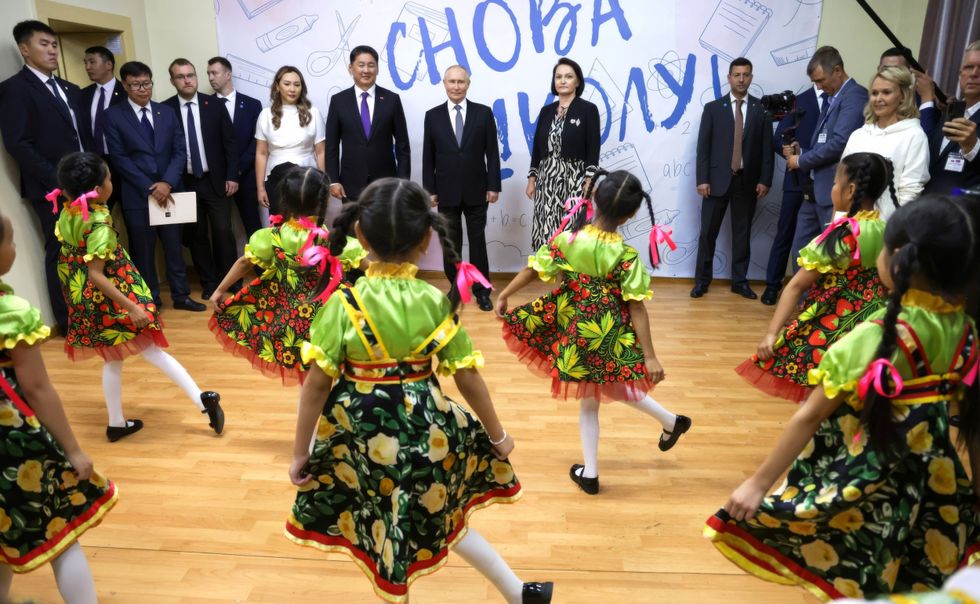 Photo of Russian President Vladimir Putin watching a choreography class of young dancers during a visit to the Plekhanov Russian University of Economics.