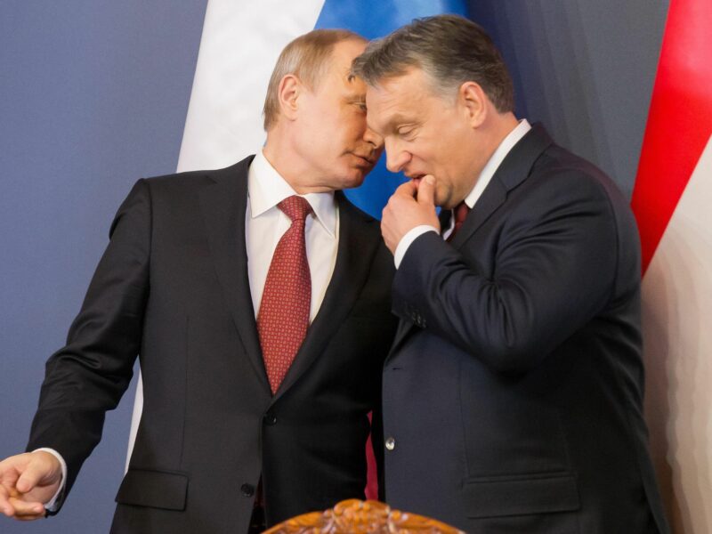 Photo of Russian President Vladimir Putin whispering in Hungarian Prime Minister Viktor Orban during a meeting in Budapest