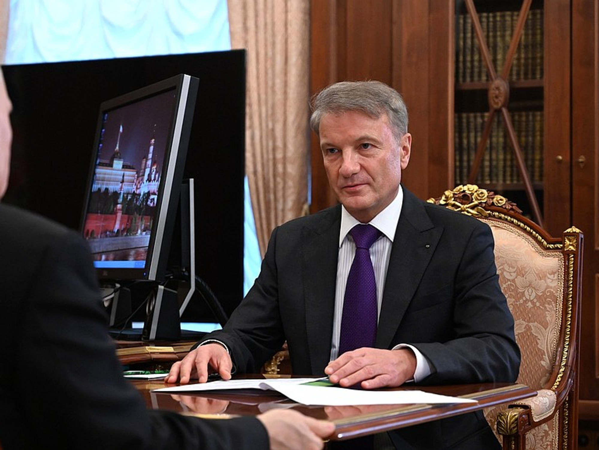 Photo of Sberbank CEO German Gref sitting in front with Russian President Vladimir Putin during a meeting at the Kremlin