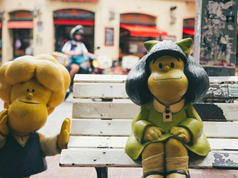 Photo of sculptures of Mafalda characters near a bench in Buenos Aires